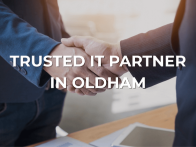 Two businesspeople shaking hands representing trusted local IT partner relationship.